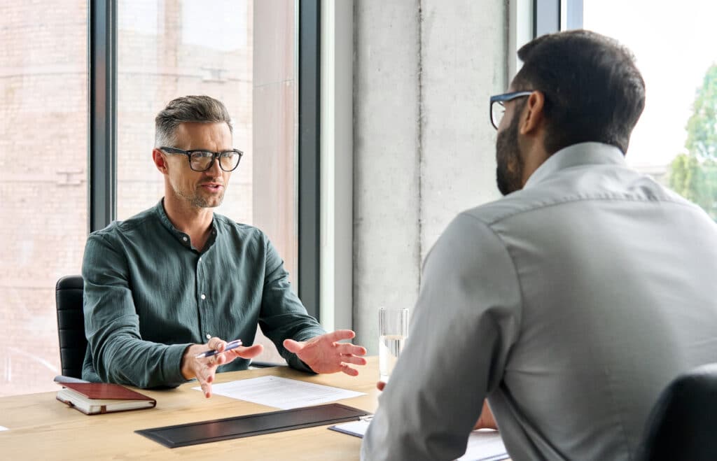 Two men in consultation at a desk