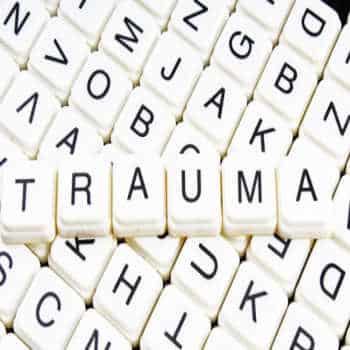 scabble pieces spelling out the word "Trauma"
