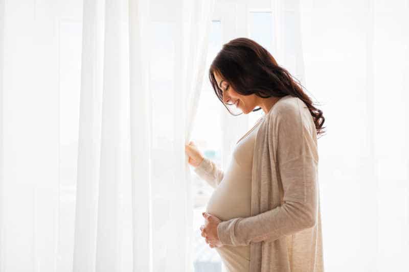Pregnant Woman caressing her baby bump