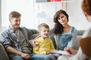 Happy Child on Sofa with Parents
