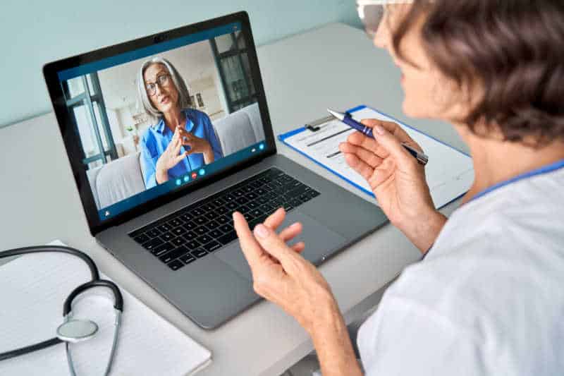 two business women on video call