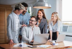 Office team gathered around a computer