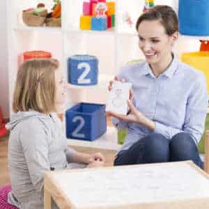 Therapist showing child a drawing in a play therapy session