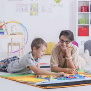 Therapist and childing playing at floor level as part of a play therapy session