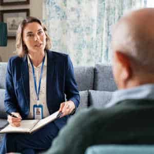 Man in therapy consultation with female clinician