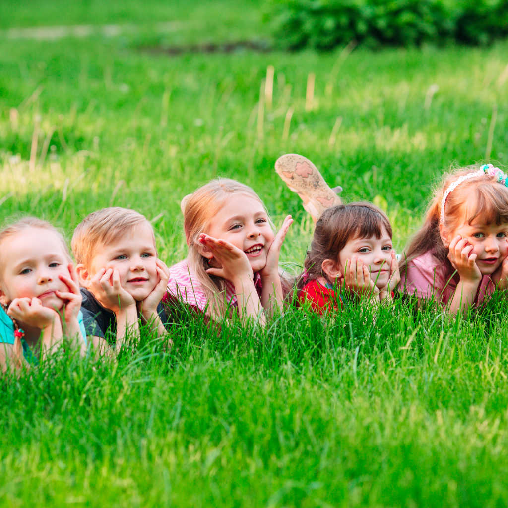 group of children lying on the grass