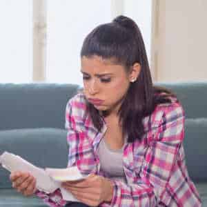 woman on sofa reading assessment paperwork