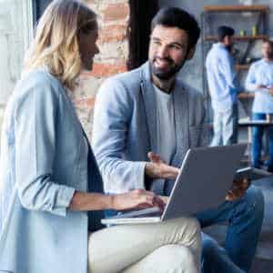 male and female employees talking informally