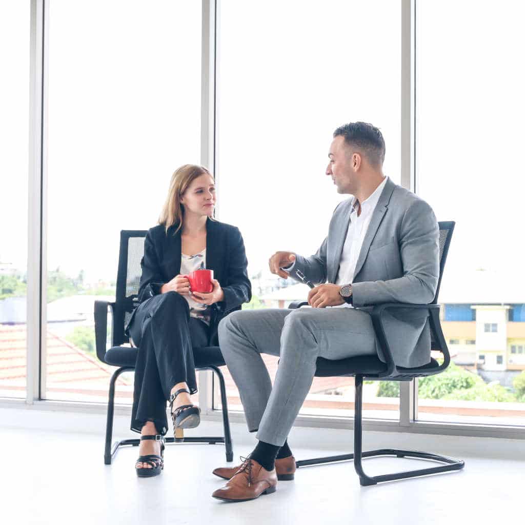 Male and Female employee in serious conversation