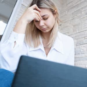 Anxious female worker at laptop