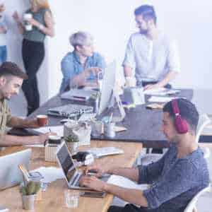 Worker in office with one wearing headphones