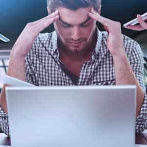 male worker looking frustrated at computer