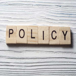 scrabble blocks spelling the word policy