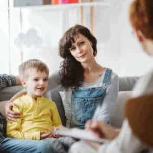 Happy small boy with mother on a sofa