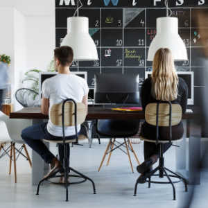 male and female worker at desk in modern office environment