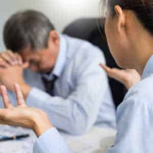 stressed male worker with female boss