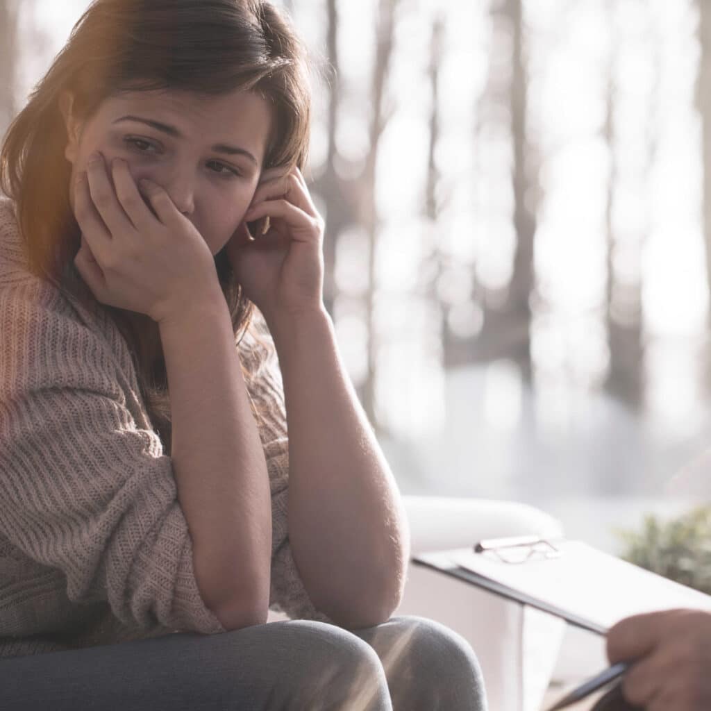 Woman in therapy session looking pensive
