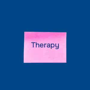 Pink post-it note with the word "Therapy written on it