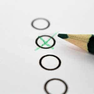 zoom in on paper questionnaire with pencil cross in multiple choice column