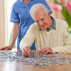 Man working on jigsaw with occupational therapist